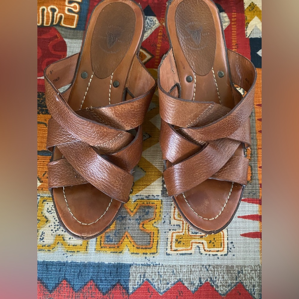 These are Frye Thomasville leather crisscross strap platform mules.